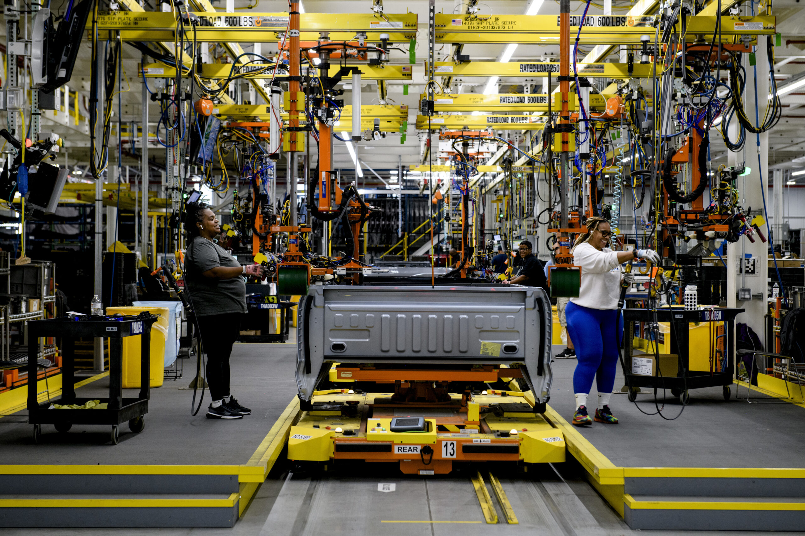 DEARBORN, MICHIGAN - September 7, 2022: Employee work on a truck bed for the Ford F-150 Lightning at the Ford Rouge Electric Vehicle Center in Dearborn, Mich., on September 7th, 2022. (Brittany Greeson for NPR)